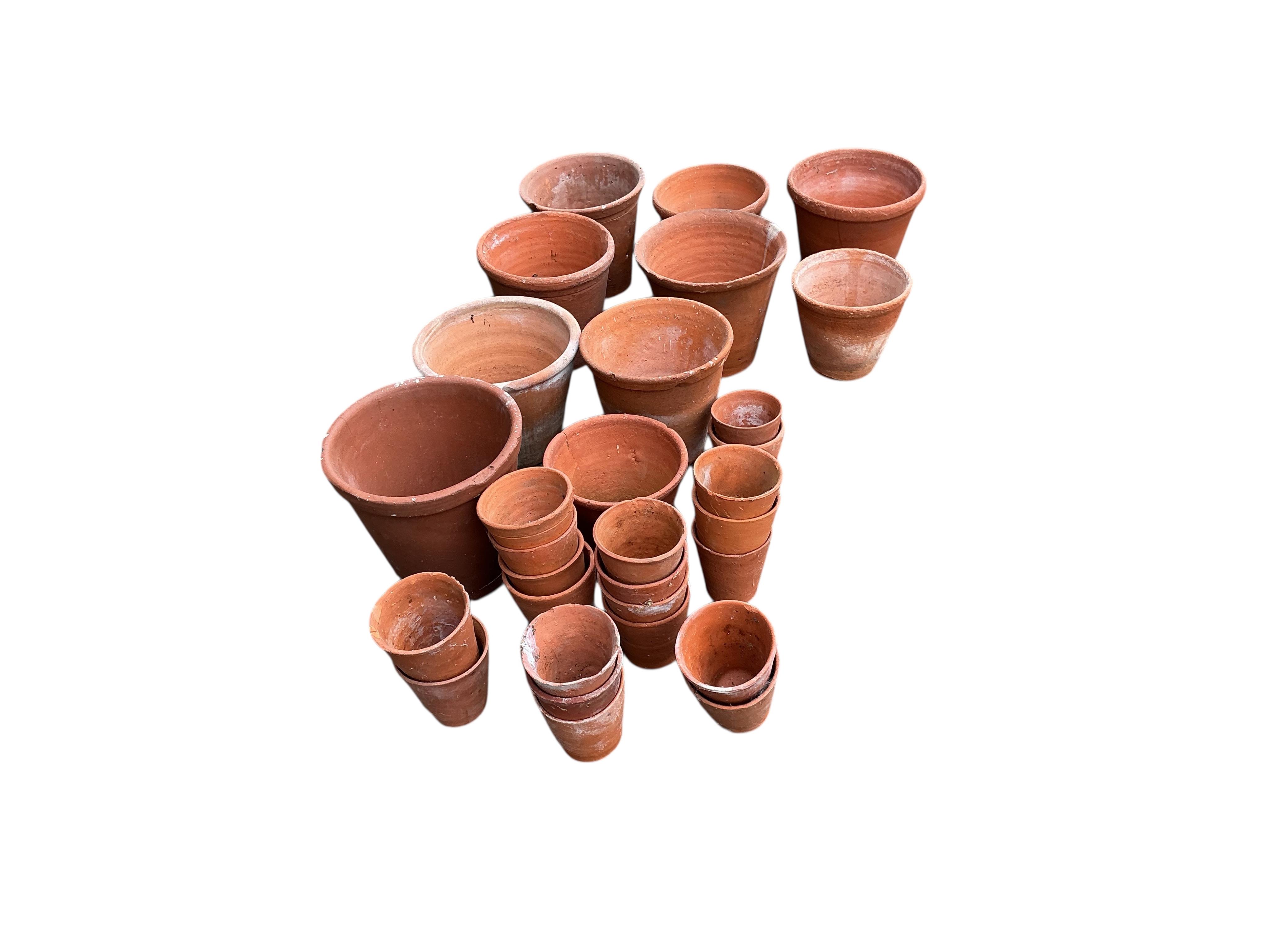 Thirty assorted circular terracotta garden pots, largest height 18cm